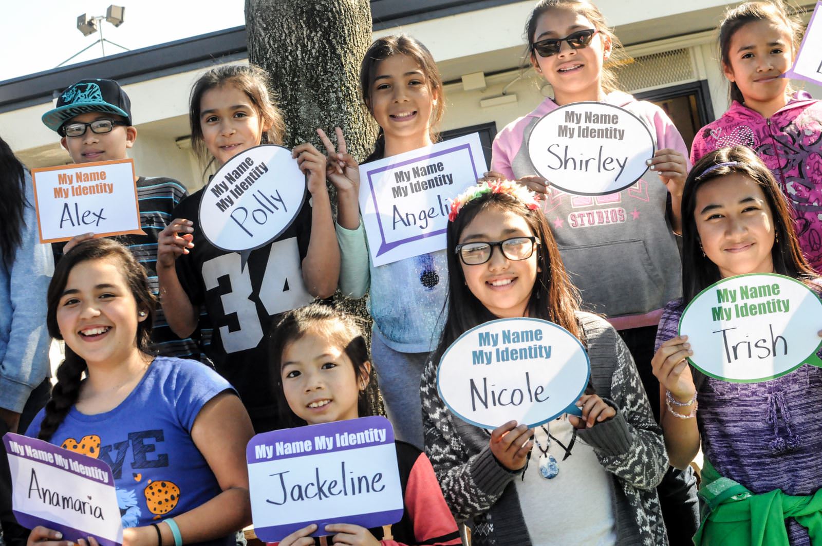 Students from Katherine Smith Elementary School holding up name tags